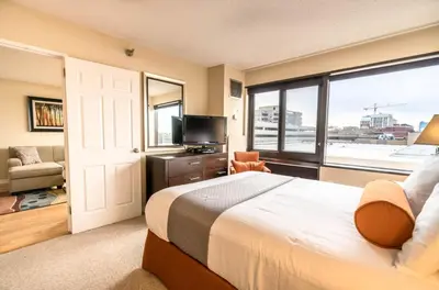 a bedroom with a large bed and a large window at Serene Apt Downtown in Stamford