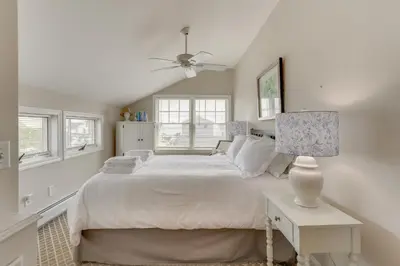a white bedroom with a large bed and a lamp at Walk to Beaches Sunny East Haven Home with Grill in West Haven