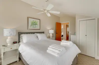 a bedroom with a white bed with towels on it at Walk to Beaches Sunny East Haven Home with Grill in West Haven
