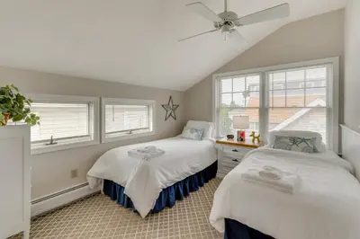 a bedroom with two beds and a ceiling fan at Walk to Beaches Sunny East Haven Home with Grill in West Haven