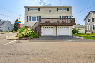 a house with two garage doors and a stop sign at Walk to Beaches Sunny East Haven Home with Grill in West Haven