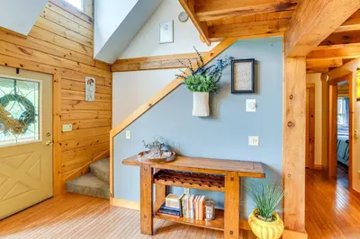 a room with a wooden door and a table at Spacious Wilmington Cabin Walk to Lake in Wilmington
