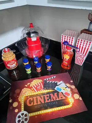 a table with a box of cinema movie mix and drinks at Fun Home in Pocono with Gameroom-Firpit-BBQ Grill-TV and AC in all rooms in Tobyhanna