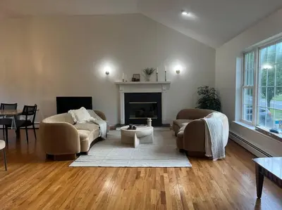 a living room with two couches and a fireplace at Cozy Beautiful Pondside Luxurious Retreat in Monroe