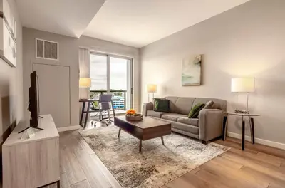 a living room with a couch and a table at Luxury Apt On Harbor in Stamford
