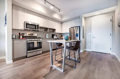 a kitchen with a table and chairs in it at Luxury Apt On Harbor in Stamford