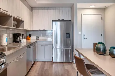a kitchen with a stainless steel refrigerator at Luxury Apt On Harbor in Stamford