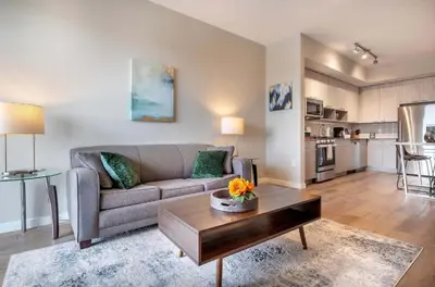 a living room with a couch and a table at Luxury Apt On Harbor in Stamford