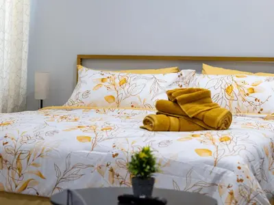 a bed with yellow towels on top of it at 4 New Apts - 3 Bed Apt 1st Floor & 3 Bed Apt 2nd Floor - 1 Bed Studio Apt Ground Floor & 1 Bed Studio Apt Ground Floor near Penn Station EWR Airport Beth Israel Hospital Manhattan NYC in East Orange