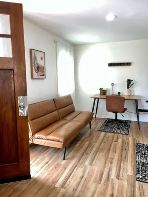 a living room with a couch and a table at Spacious 4BR home w 2BA, a workspace & king bed! in Fort Plain