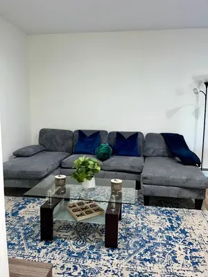 a living room with a couch and a glass table at Spacious 4BR home w 2BA, a workspace & king bed! in Fort Plain