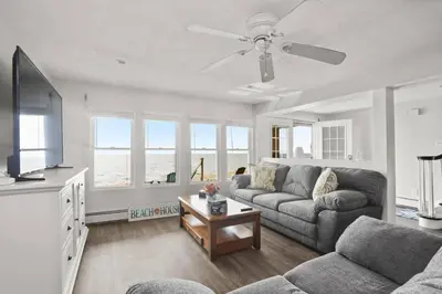 a living room with a couch and a flat screen tv at Pet Friendly Milford Beachfront Home in Stratford