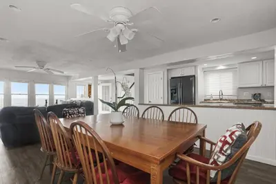 a kitchen and dining room with a wooden table and chairs at Pet Friendly Milford Beachfront Home in Stratford