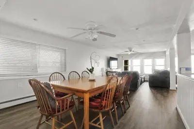 a dining room and living room with a table and chairs at Pet Friendly Milford Beachfront Home in Stratford