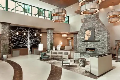 a lobby of a hotel with a fireplace at Embassy Suites Saratoga Springs in Saratoga Springs