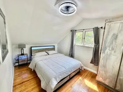 a bedroom with a large bed and a window at Town & Country Andover, NJ Area Apt- 2nd FL in Andover
