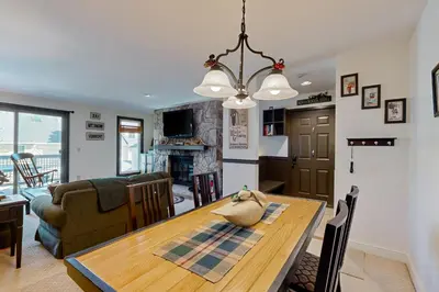 a kitchen and living room with a table and a couch at The Seasons G27 in Dover