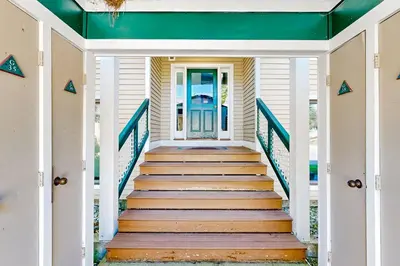 a staircase leading to the front door of a house at The Seasons G27 in Dover