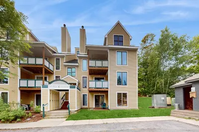 an exterior view of a large apartment building at The Seasons G17 in West Dover