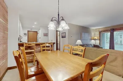 a dining room and kitchen with a table and chairs at The Seasons G17 in West Dover