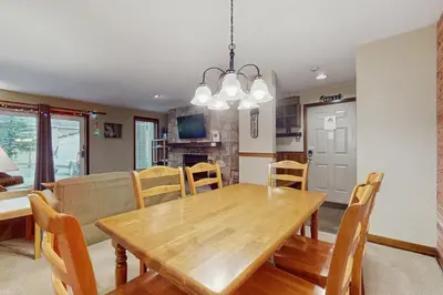 a dining room and kitchen with a wooden table and chairs at The Seasons G17 in West Dover