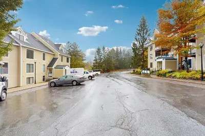 a wet street with a car parked on the street at The Seasons G17 in West Dover