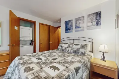 a bedroom with a bed and a table with a lamp at The Seasons G17 in West Dover