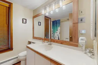 a bathroom with a sink and a mirror at The Seasons G17 in West Dover