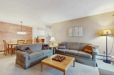 a living room with two couches and a table at The Seasons G17 in West Dover
