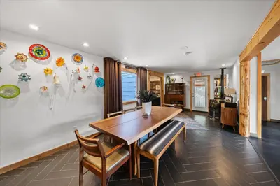 a dining room with a wooden table and chairs at Green Acres Retreat in Hancock