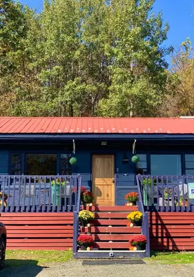a blue and red house with a red roof at Green Acres Retreat in Hancock