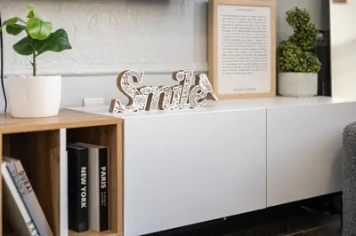 a white cabinet with a book shelf with books at 