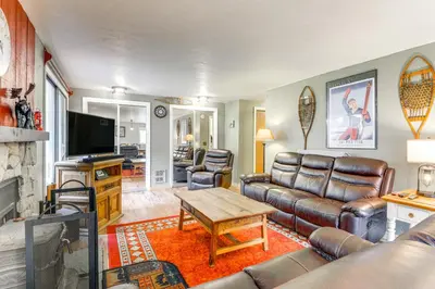 a living room with a couch and a table at West Dover Townhome Hot Tub, 2 Mi to Mount Snow! in West Dover