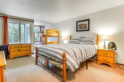 a bedroom with a bed and a window at West Dover Townhome Hot Tub, 2 Mi to Mount Snow! in West Dover