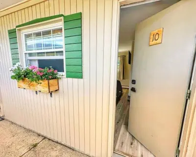 a house with a window with flowers on it at Brittany Motel in Sunderland