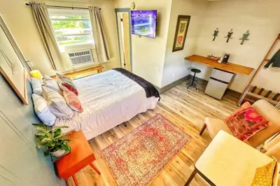 a bedroom with a bed and a living room at Brittany Motel in Sunderland