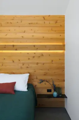 a bedroom with a wooden accent wall and a bed at Coldbrook Bed and Breakfast in Bearsville