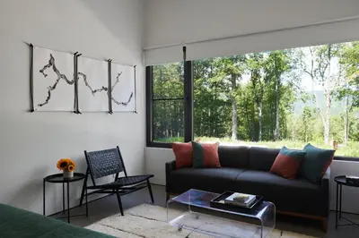 a living room with a couch and a large window at Coldbrook Bed and Breakfast in Bearsville