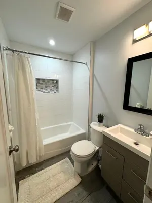a bathroom with a tub and a toilet and a sink at Solano Inn in Portland
