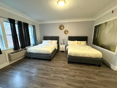 a bedroom with two beds and two windows at Solano Inn in Portland