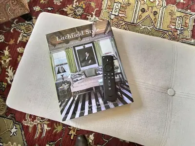 a book with a camera sitting on top of a table at Historic Colonial Pool Walk to Town in Litchfield