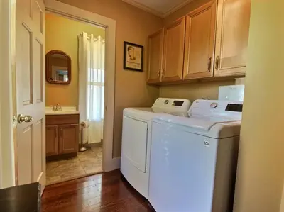 a kitchen with a washer and dryer in a room at Historic Colonial Pool Walk to Town in Litchfield