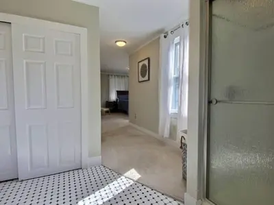 an empty room with a white door and a window at Historic Colonial Pool Walk to Town in Litchfield