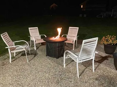 four chairs around a table with a fire pit at Historic Colonial Pool Walk to Town in Litchfield