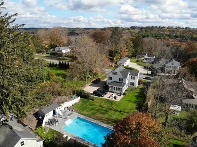 an aerial view of a house with a swimming pool at Historic Colonial Pool Walk to Town in Litchfield
