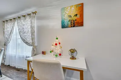 a white table with a christmas tree on it at 1 Mi to MGM Springfield Cozy Winter Duplex! in Springfield