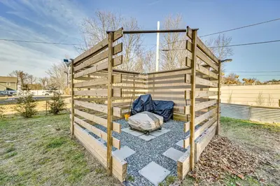 a wooden fence with a tent in a yard at 1 Mi to MGM Springfield Cozy Winter Duplex! in Springfield