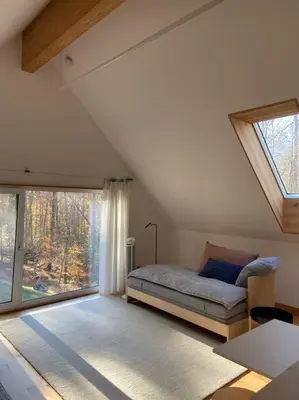 a bedroom with a bed and a large window at Modern Mountain Retreat in Mount Tremper