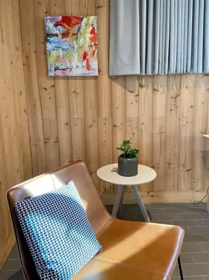 a room with a chair and a table with a plant at Modern Mountain Retreat in Mount Tremper