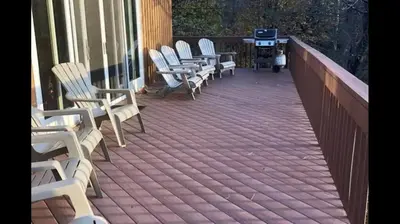 a row of chairs sitting on a deck at Beautiful Windham Chalet 2 minutes to the Mountain in Windham